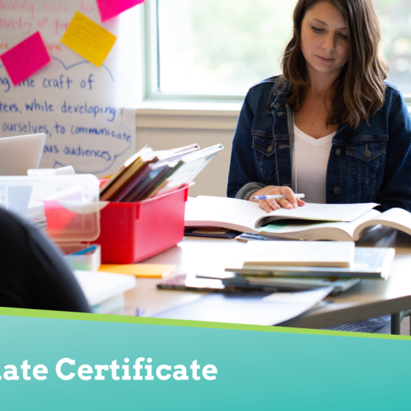 Woman sitting at a table reading.