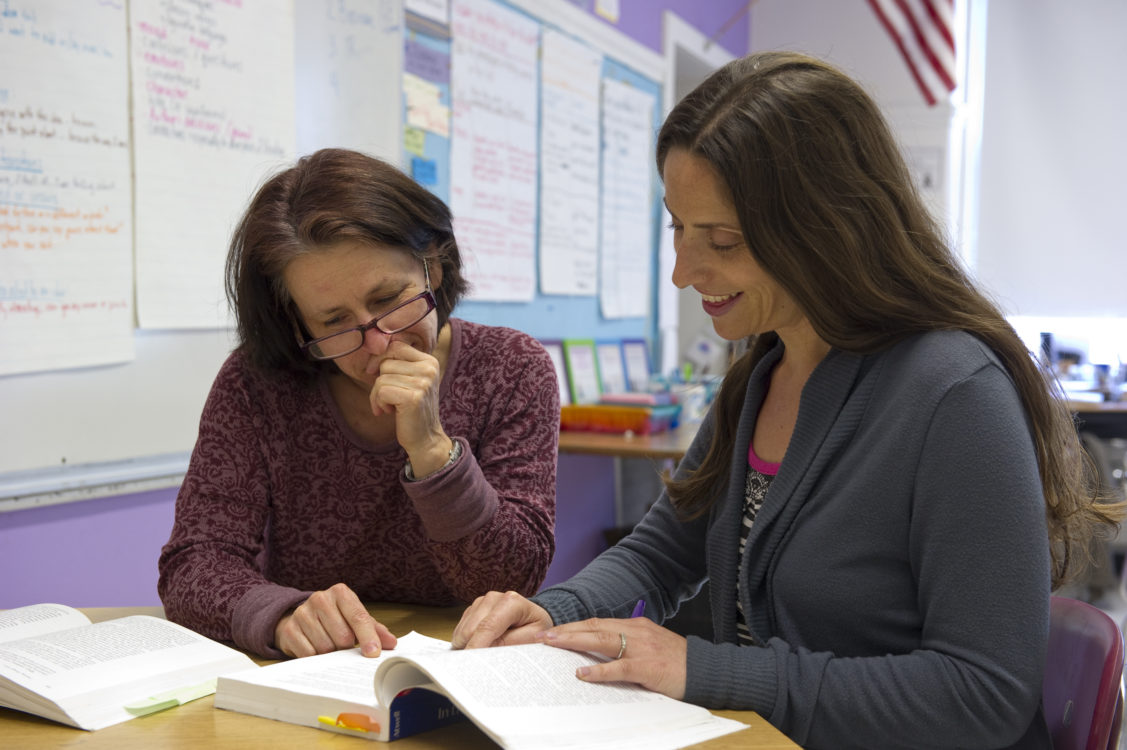 Two adults studying