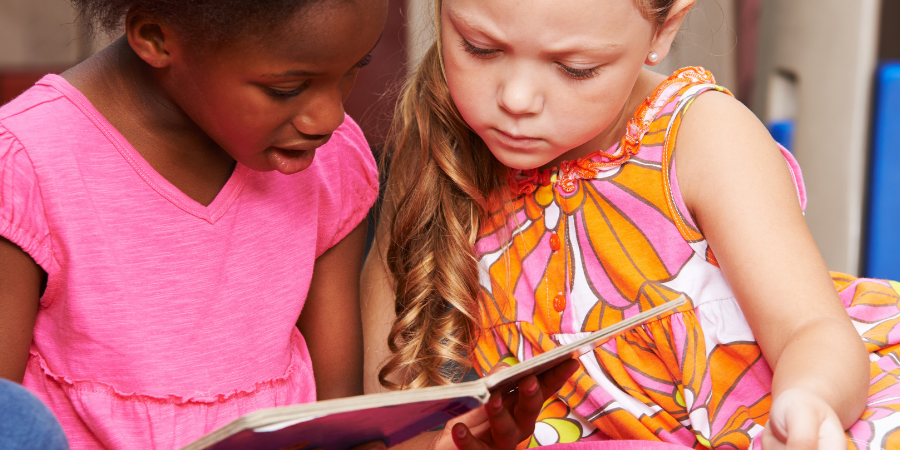 Young students reading a picture book.