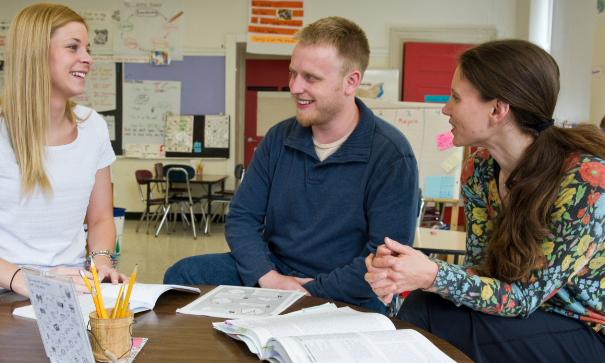 Three teachers talking.